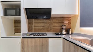Eine moderne Küche mit Mikrowelle, Herd und Kaffeemaschine.