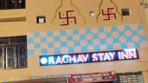 A building with a checkered facade and a neon sign for Raghav Stay Inn. - RAGHAV STAY INN (Faizabad)