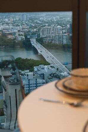A cityscape with a bridge, buildings, and a river.