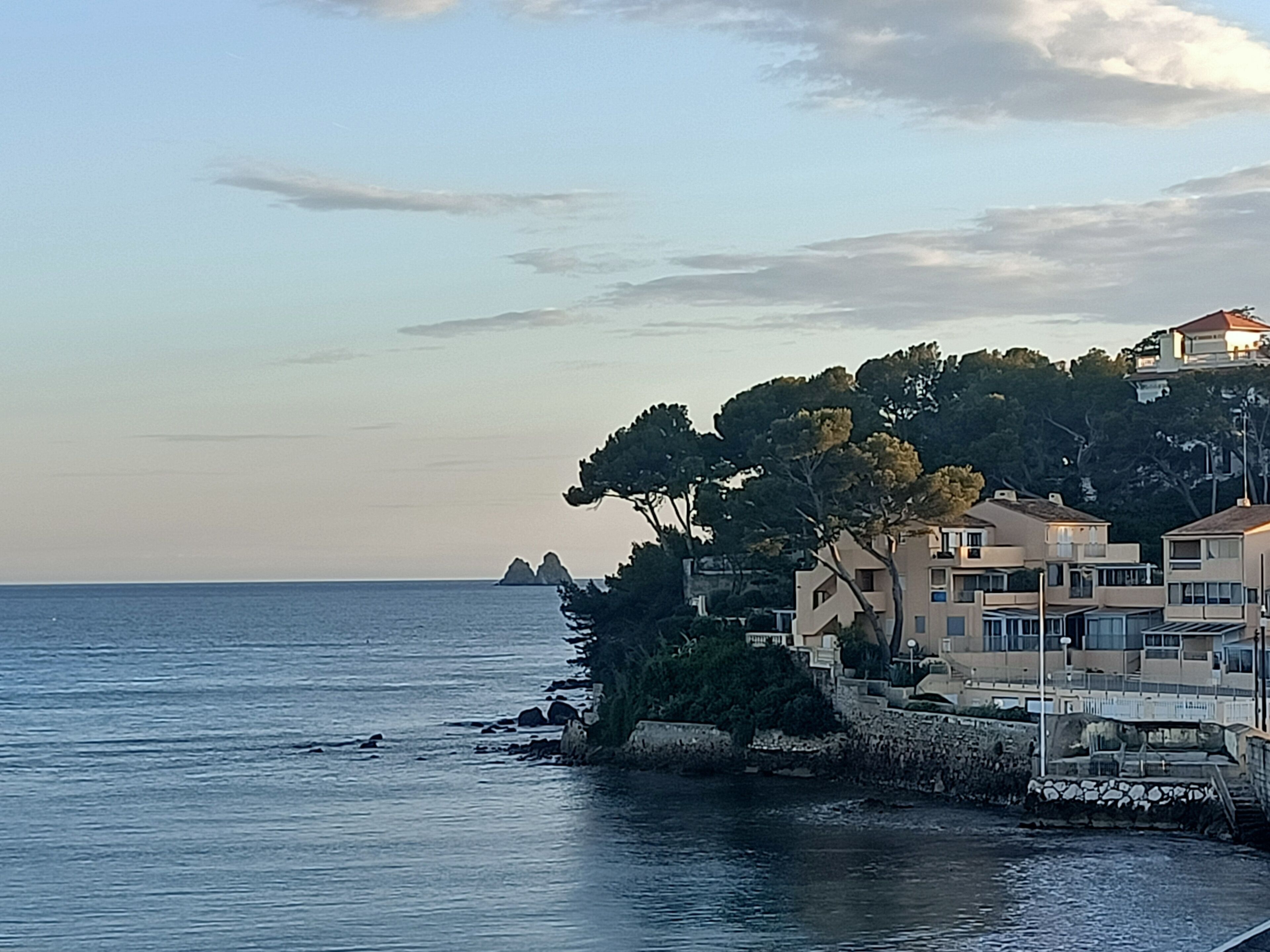 A coastal building with multiple balconies overlooking the sea.