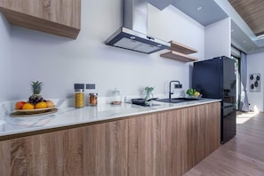 A modern kitchen with a wooden island, stainless steel appliances, and a built-in oven.
