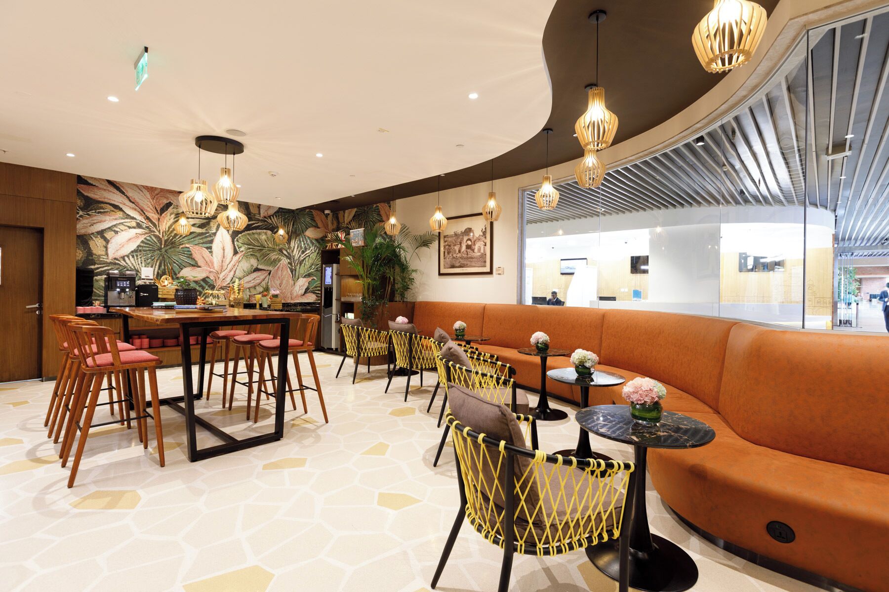 A modern hotel lobby with a bar area, seating arrangements, and a reception desk.