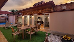 A residential property with a patio, a dining area, a swimming pool, and a garage. - Balinese 3BR Pool Villa Freya in Rawai (Rawai)