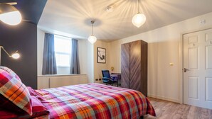 A bedroom with a bed, a desk, a chair, a wardrobe, and a door. - Crookesmoor View, Sheffield (South Yorkshire)