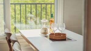 A balcony with a table, a table lamp, a bottle, and two glasses. - Gapyeong Laonjena Pool Villa (Gapyeong)