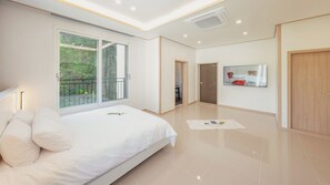 A modern bedroom with a large bed, a sliding glass door to a balcony, and a flat-screen TV on the wall. - Gapyeong Laonjena Pool Villa (Gapyeong)