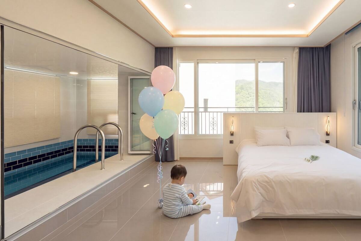 A modern hotel room with a large bed, a balcony, a swimming pool, and a child reading a book.