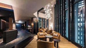 A modern lobby with a reception desk, seating area, and large windows. - THE GATE HOTEL SAPPORO by HULIC (Sapporo)