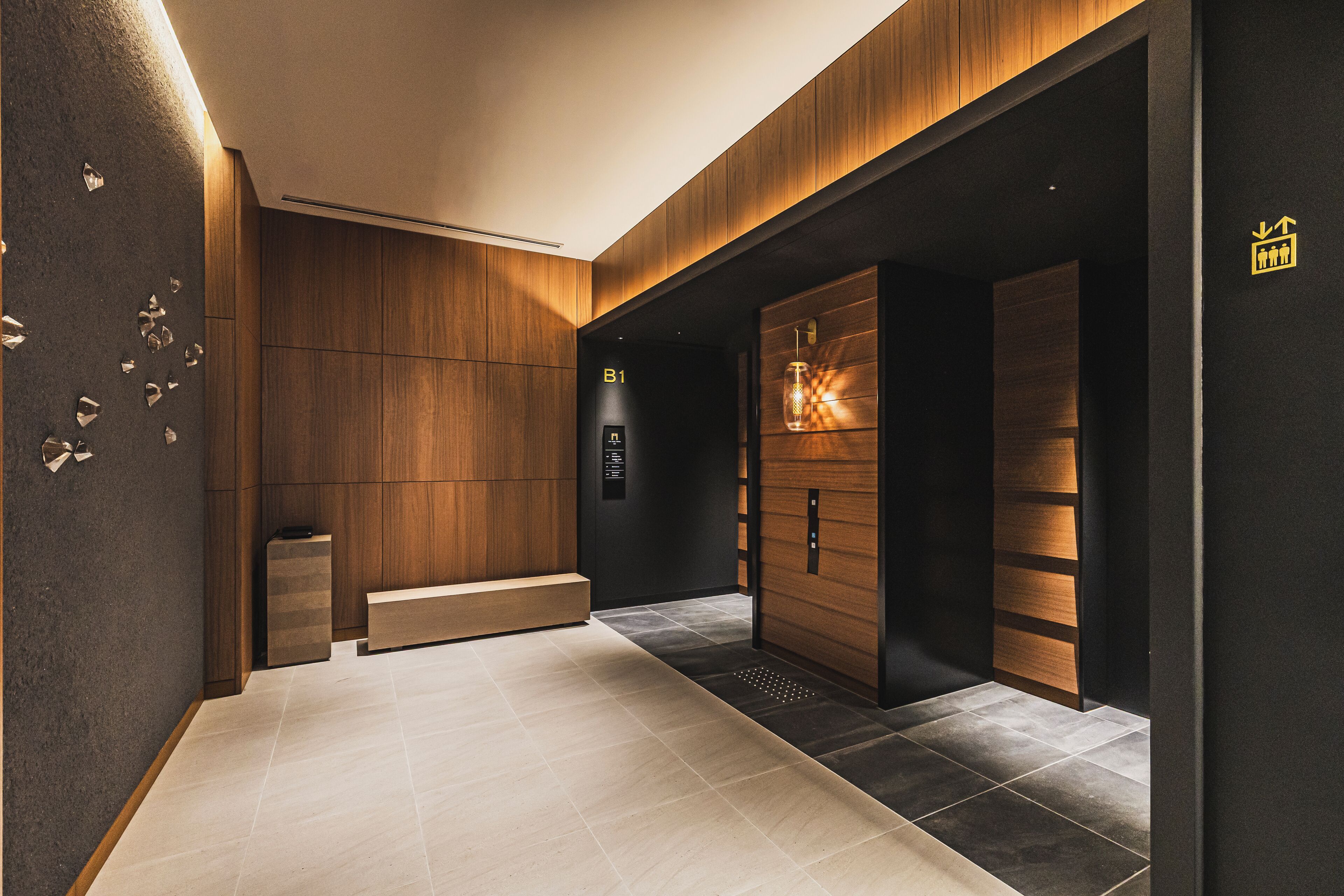 A modern elevator with a wooden finish and a digital display.