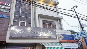 A hotel named "Hotel Sarvad Wood" with a signboard indicating its address. - Sandalwood (Meerut)