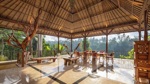 A spacious covered area with a tiled floor, wooden furniture, and a large tree sculpture. - The Allure Ubud Villas & Spa crafted by freshWater Asia (Ubud)