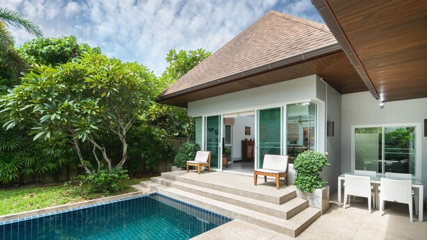 A modern house with a swimming pool, outdoor seating, and lush greenery. - Tropical 3BR Pool Villa Morning Forest  (Rawai)