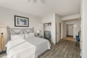 A bedroom with a bed, bedside lamps, a framed picture, and a view into another room. - Origin 635 + 637: Incredible Views + Ultimate Privacy (Panama City Beach)