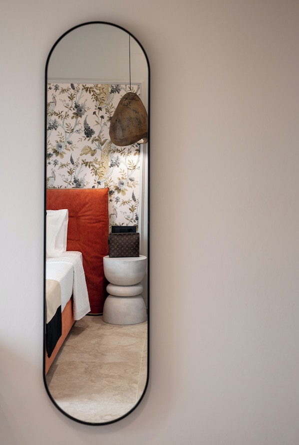 A bathroom with a toilet, a sink, and a mirror.