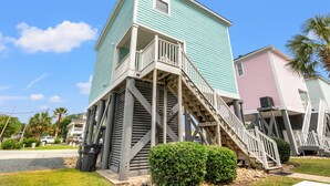 A two-story building with a wooden staircase leading to a balcony.