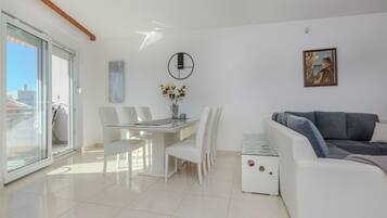 Standard Apartment, Garden View | Living area | 100-cm LCD TV with satellite channels