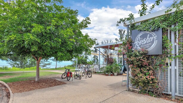 A restaurant with a sign, bicycles, and a tree. - Self contained studio apartment overlooking the beautiful Nightcliff foreshore with your own private balcony. (Nightcliff)
