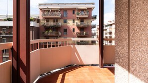 A multi-story residential building with balconies, a tiled terrace, and a clear sky. - Appartamento Matthias by Wonderful Italy (Bari)