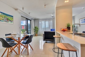 Enjoy a clean and functional living space with a dining area, kitchen, and comfortable seating.