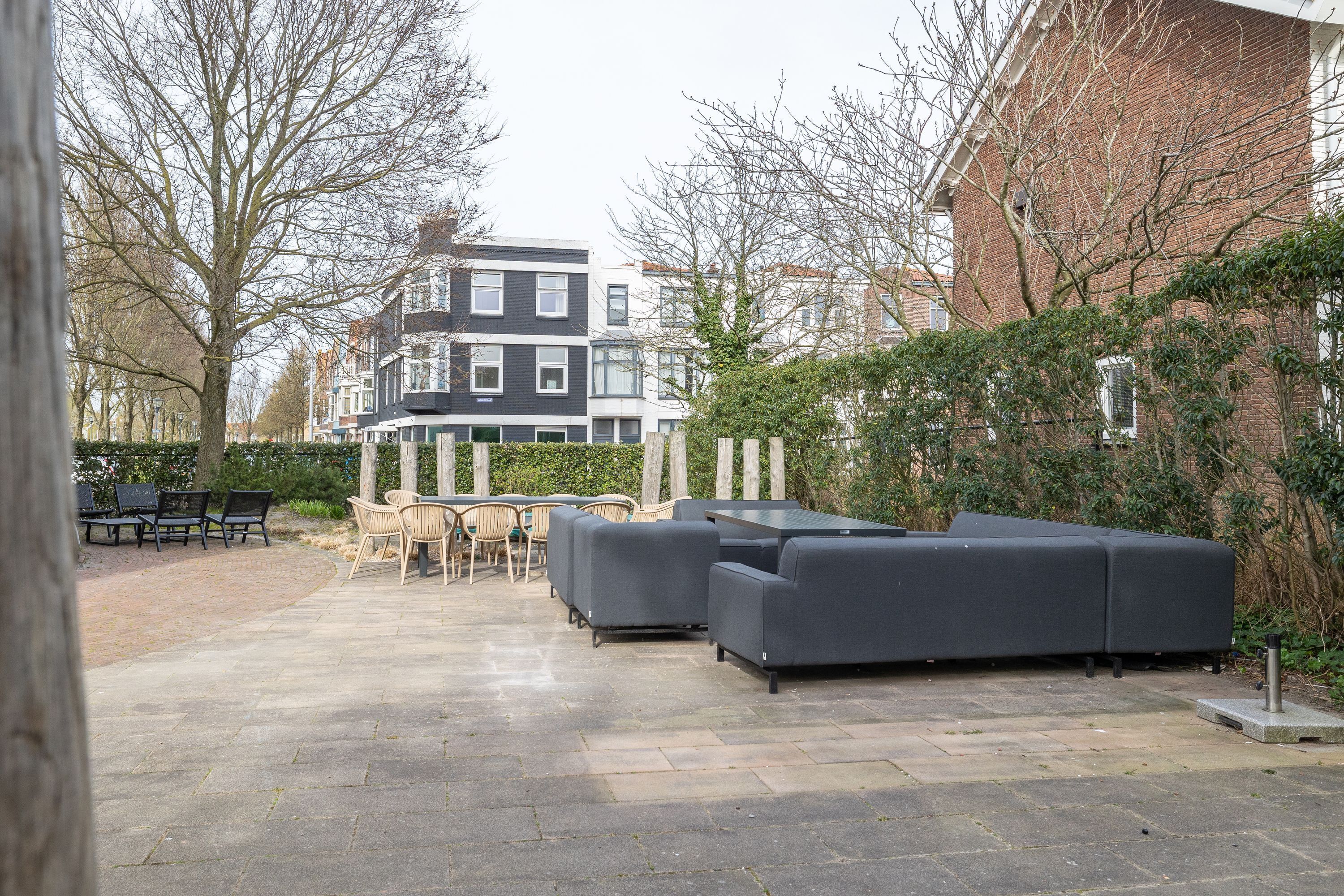 An outdoor patio area with seating and a view of residential buildings.