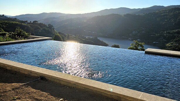 A swimming pool with a view of a lake and mountains in the background. - Quinta D'Joanes Douro (Resende)