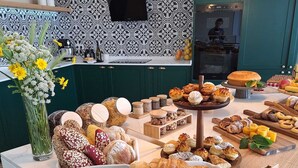 A kitchen with a variety of baked goods and pastries displayed on a counter. - Quinta D'Joanes Douro (Resende)