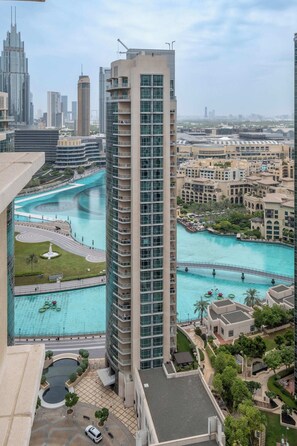 A high-rise hotel with a view of a turquoise water body and surrounding buildings. - Bellavista- 1 Bedroom Apartment- 29 BLVD (Dubai)