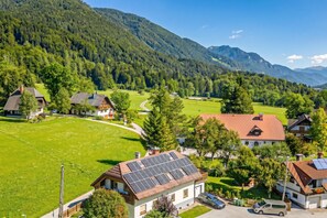 A rural village with houses, a winding road, and mountains in the background. - Alpine Chalet Planica With Sauna (Kranjska Gora)