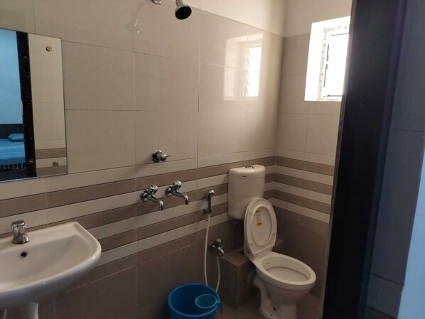Une salle de bain avec un lavabo, des toilettes et un miroir.