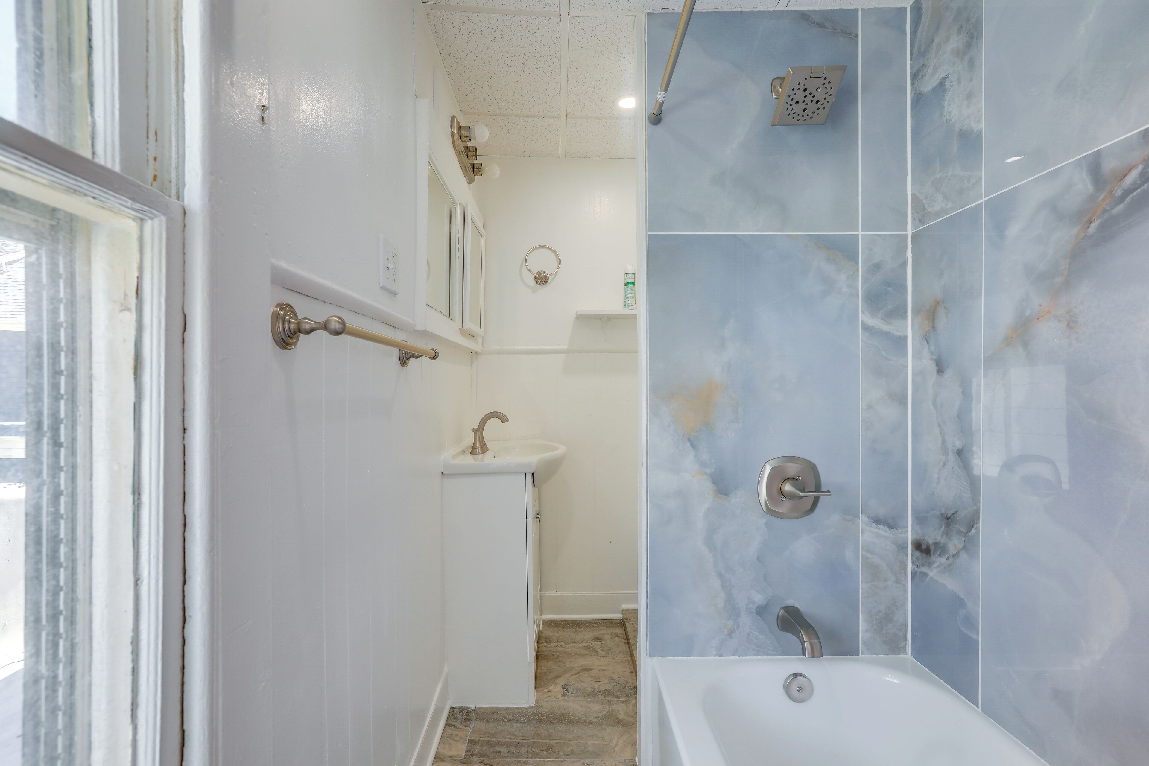 A bathroom with a bathtub, a sink, and a shower.