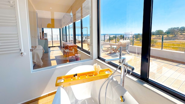 A modern bathroom with a large window, a sink, and a wooden ladder. - Villa Alba Luxe et Confort a Hammamet (Hammamet)