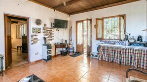 A spacious kitchen with a tiled floor, wooden ceiling, and a dining area with a table set for two. - Nice home in Ragusa with house a panoramic view (Ragusa)