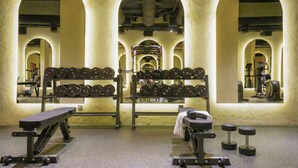 A gym with weightlifting equipment, benches, and mirrored walls. - LIV by Yamama - KAFD (Riyadh)