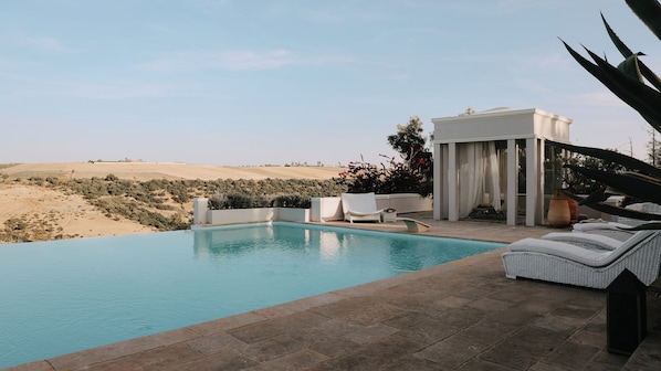 Outdoor pool, open 8:00 AM to 7:00 PM, pool umbrellas, pool loungers