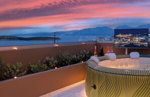 A rooftop terrace with a view of a cityscape at sunset, a pool table, and ambient lighting. - Evilion Home 2 (Agios Nikolaos)