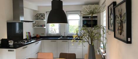 Enjoy cooking in this well-equipped kitchen with a central island, gas stove, and sink.