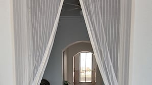 A hallway with a tiled floor leading to a room with a bed and a potted plant. - Big and comfortable country house with garden in "Finca La Guindilla" with Pool (El Pico)