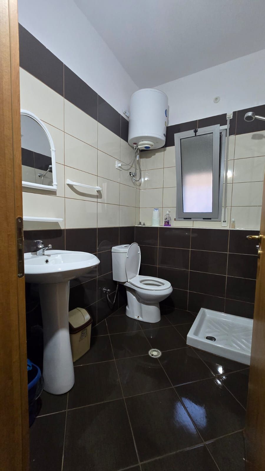 A bathroom with a sink, toilet, and bidet.