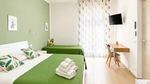 A hotel room with two beds, a desk, a television, and a window with curtains. - B&B Le Venere Rooms (Castellammare del Golfo)