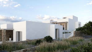 Une villa moderne dotée d’un mur de soutènement en pierre, d’une piscine et d’un escalier menant à un deuxième niveau.