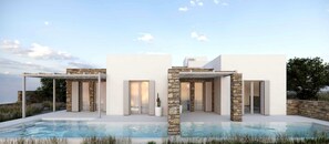 Une maison moderne dotée d’une piscine, de piliers en pierre et de murs blancs.