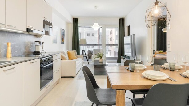 A modern apartment with a kitchen, dining area, and living space. - Superior Queen Room in Tammela Soccer Stadium! (Tampere)