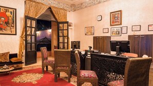 A traditional room with a desk, chairs, a computer, and a fireplace. - Hapimag Resort Marrakesh (Marrakech)
