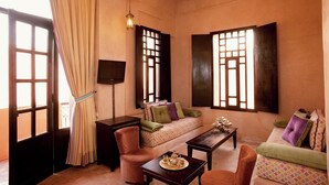 A cozy room with a sofa, armchairs, a small table, and a TV. - Hapimag Resort Marrakesh (Marrakech)
