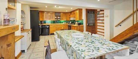 Enjoy meals in the well-equipped kitchen and dining area, featuring a dining table and comfortable seating.