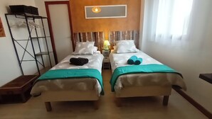 A room with two beds, a nightstand with a lamp, a ladder, and a wooden bench. - Guest rooms upstairs.  Breakfast included.  (Saillenard)