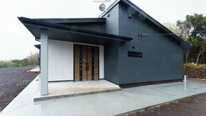 A modern house with a sloped roof, a satellite dish, and a small porch. - CS RESORT (Miyakejima)