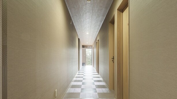 A corridor with checkered flooring, wooden doors, and textured walls. - CS RESORT (Miyakejima)
