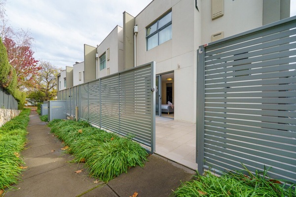 An accessible doorway leading to the communal garden area, offering a convenient outdoor retreat for residents and guests.