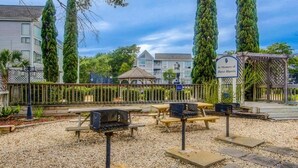 A park with picnic tables, a barbecue grill, and a gazebo. - Cute 2br Condo. Short walk to the beach. Close to shopping, restaurants & golf. (Myrtle Beach)